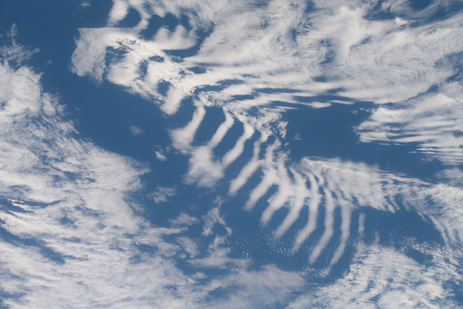 A picture taken from space of oddly-regular rippling clouds.